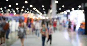 Busy exhibit hall at a convention.